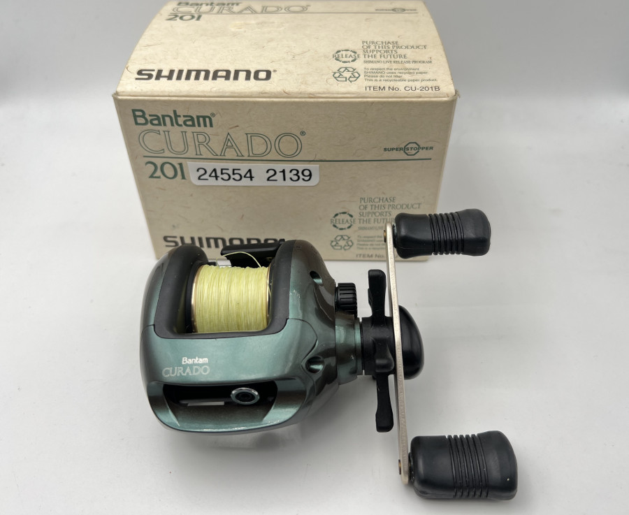 Multirolle, Shimano - Product of Japan, Bantam Curado 201, Linkshand, mit geflochtener Berkley Schnur, 0,30mm stark, ungefischt , im Karton